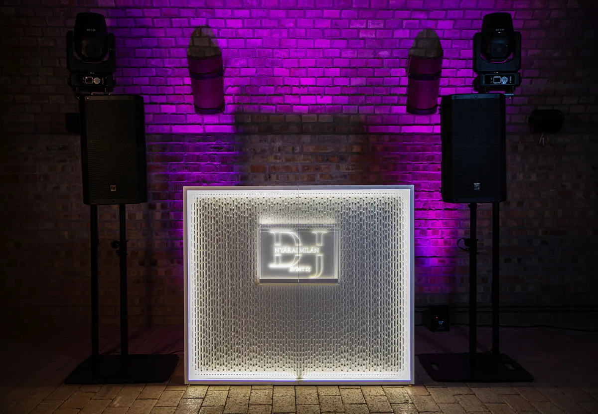 Light Stereo booth with illuminated frame and Nyárai Milán customer logo against a brick wall.