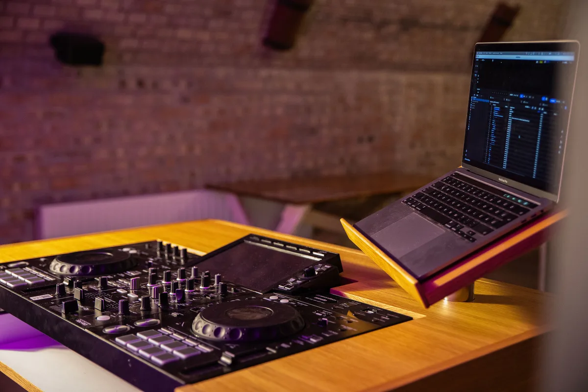 Mono work surface with DJ equipment and laptop stand.