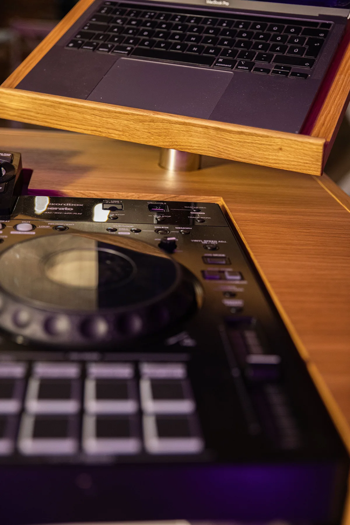 Close-up of the wood-appearance laptop stand and work surface.